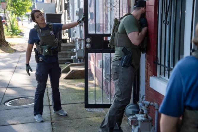 U.S. Marshals and law enforcement officers conduct an operation at a residence as part of their enforcement activities.